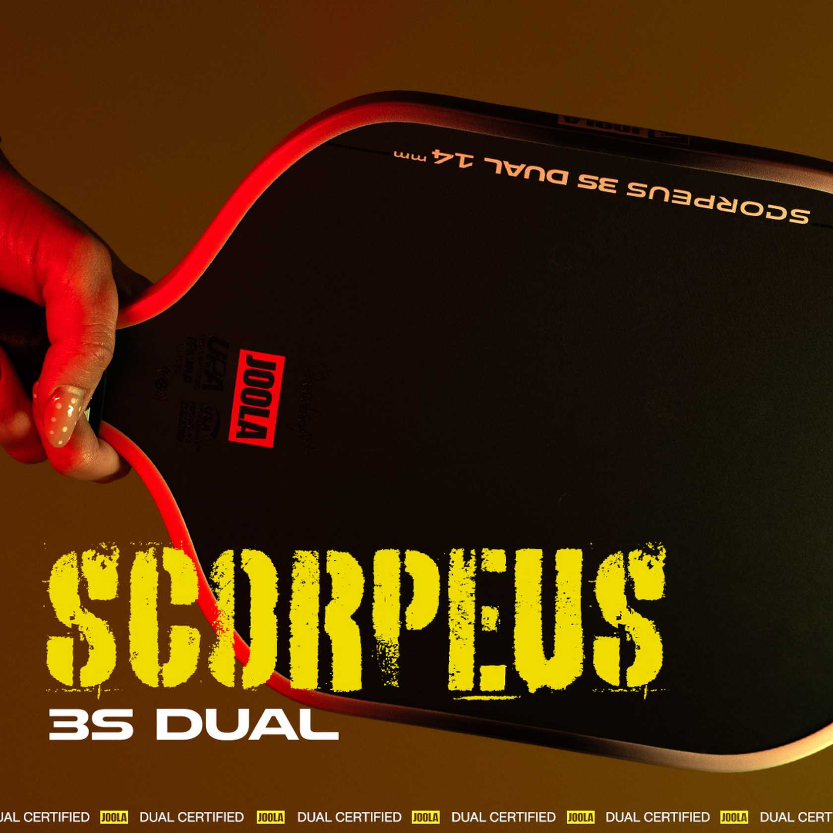 Hand holding a Scorpeus 3S Dual pickleball paddle.