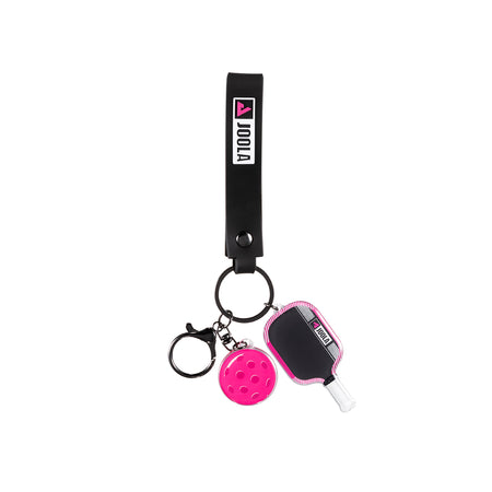 Magnus Pro IV keychain with paddle and ball charms on a white background