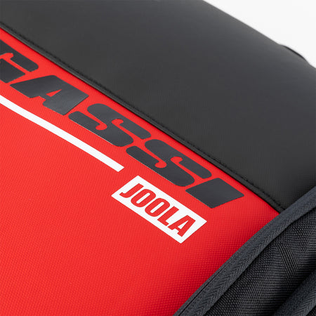 Close up on the red, black and white Agassi x JOOLA word mark on the Agassi Vision II deluxe backpack.