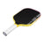 Pickleball paddle with black playing surface, yellow frame, and white handle on a white background.