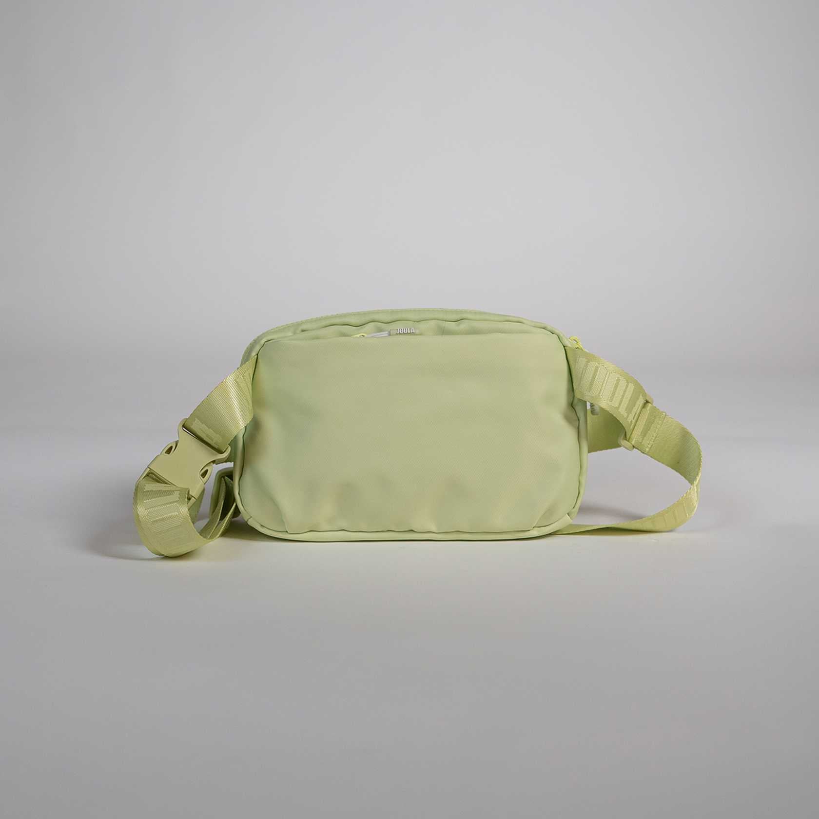 Light green waist bag on a gray background.