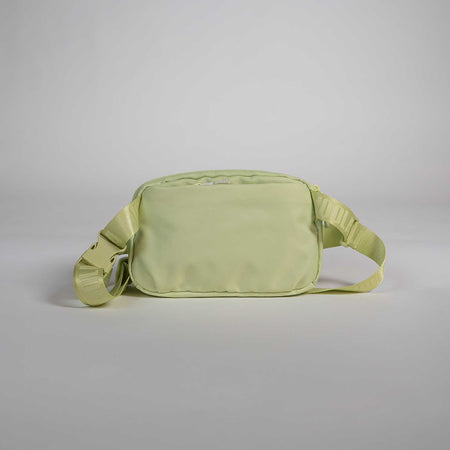 Light green waist bag on a gray background.