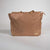 Brown bag with a visible JOOLA brand label on a light gray background
