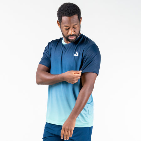 White background, product image showing a Man posing in a light blue and navy blue JOOLA Men's Table Tennis competition shirt.