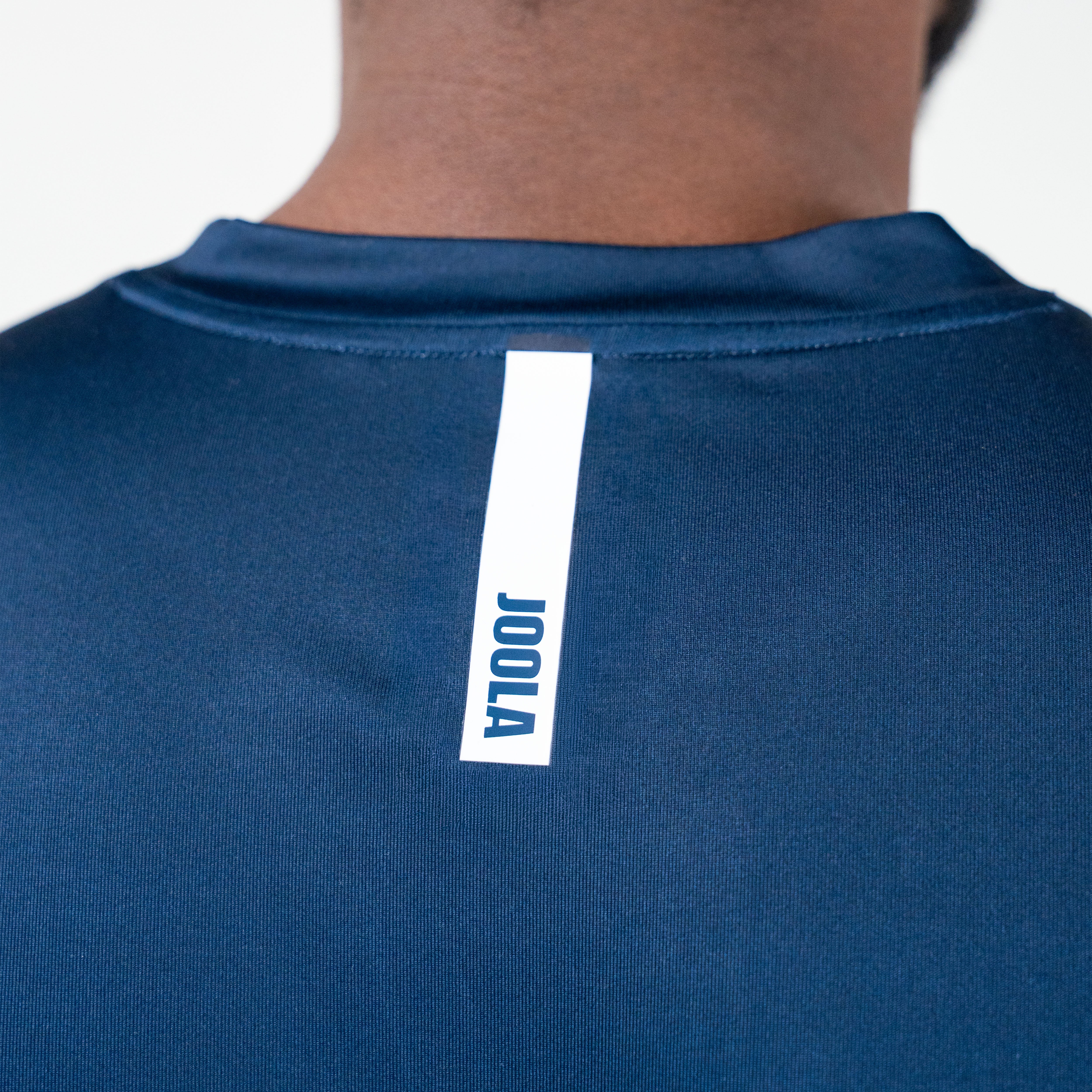 White background, image showing the back of a JOOLA Men's Table Tennis Shirt.