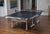 Image showing the JOOLA Rapid Play indoor table tennis table set up inside.