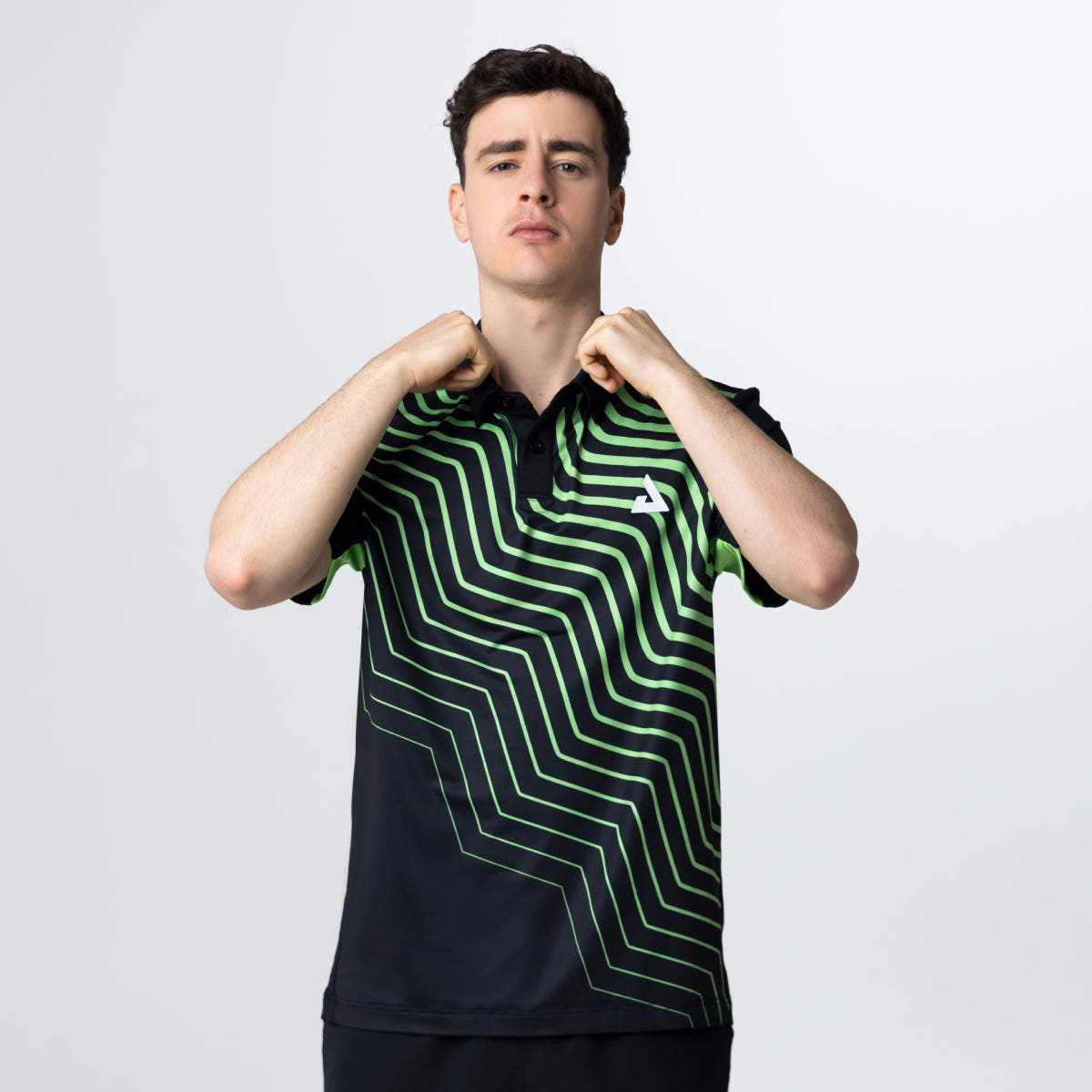 Person wearing a black and green striped shirt with a logo on a white background