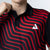 Person wearing a black and red striped polo shirt with a white JOOLA Trinity logo on a light gray background
