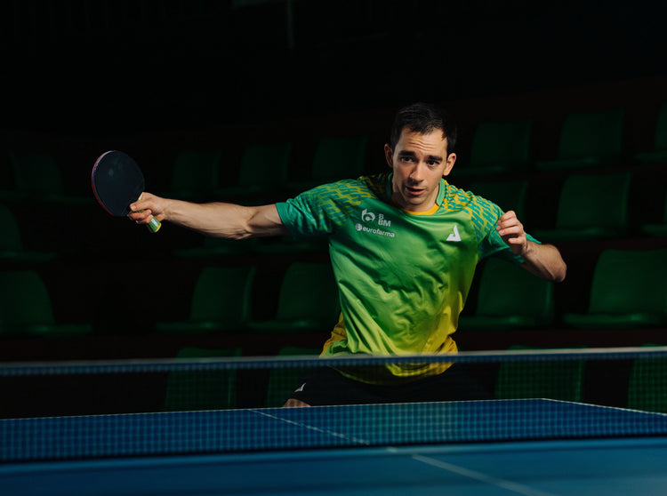 Image of JOOLA Table Tennis Pro Hugo Calderano playing table tennis with JOOLA shirts.