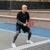 Close up image of Agassi at the Kitchen line holding a Agassi x JOOLA pickleball paddle.