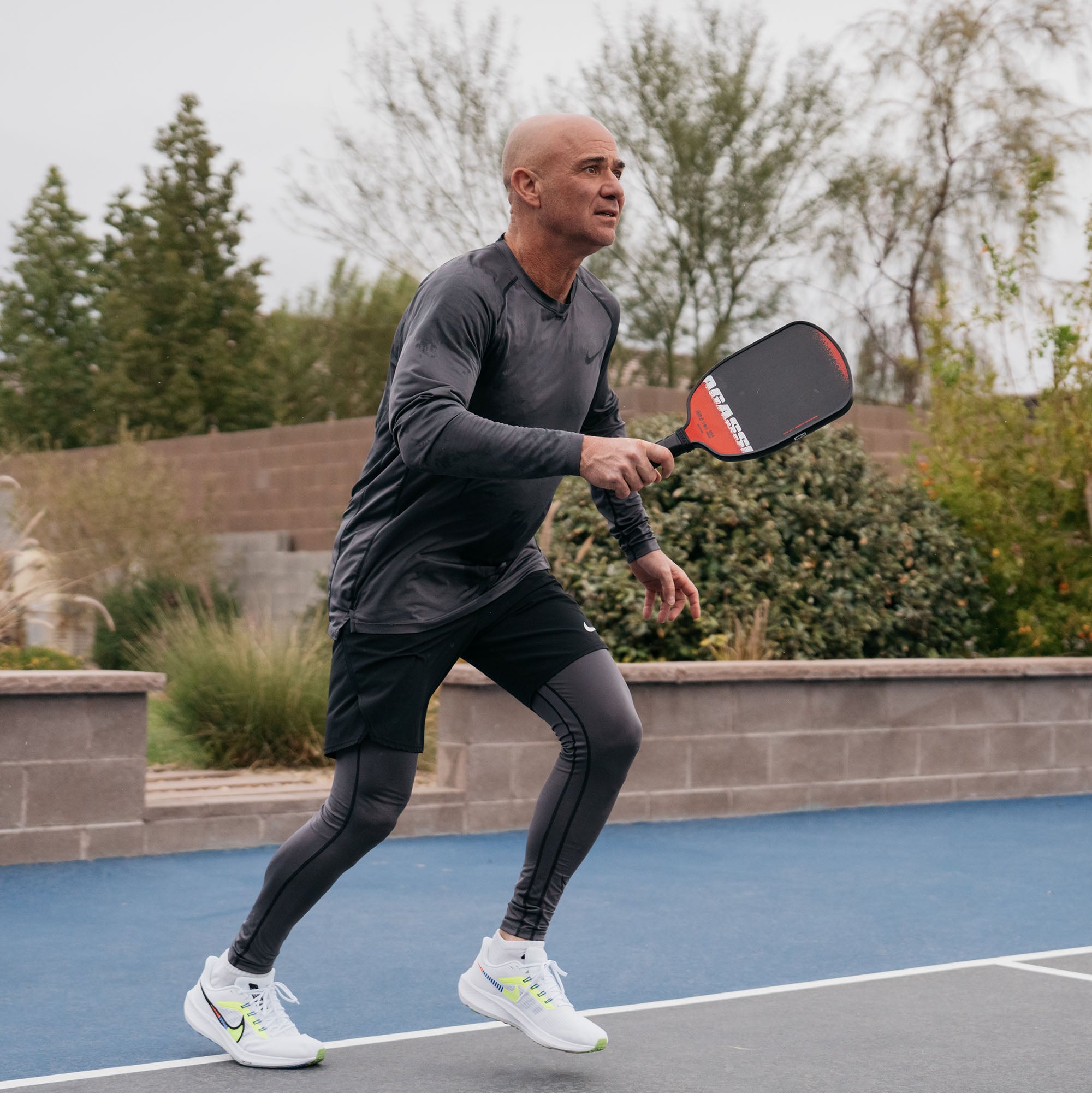 Web image of Andre Agassi holding a Agassi x JOOLA pickleball paddle.