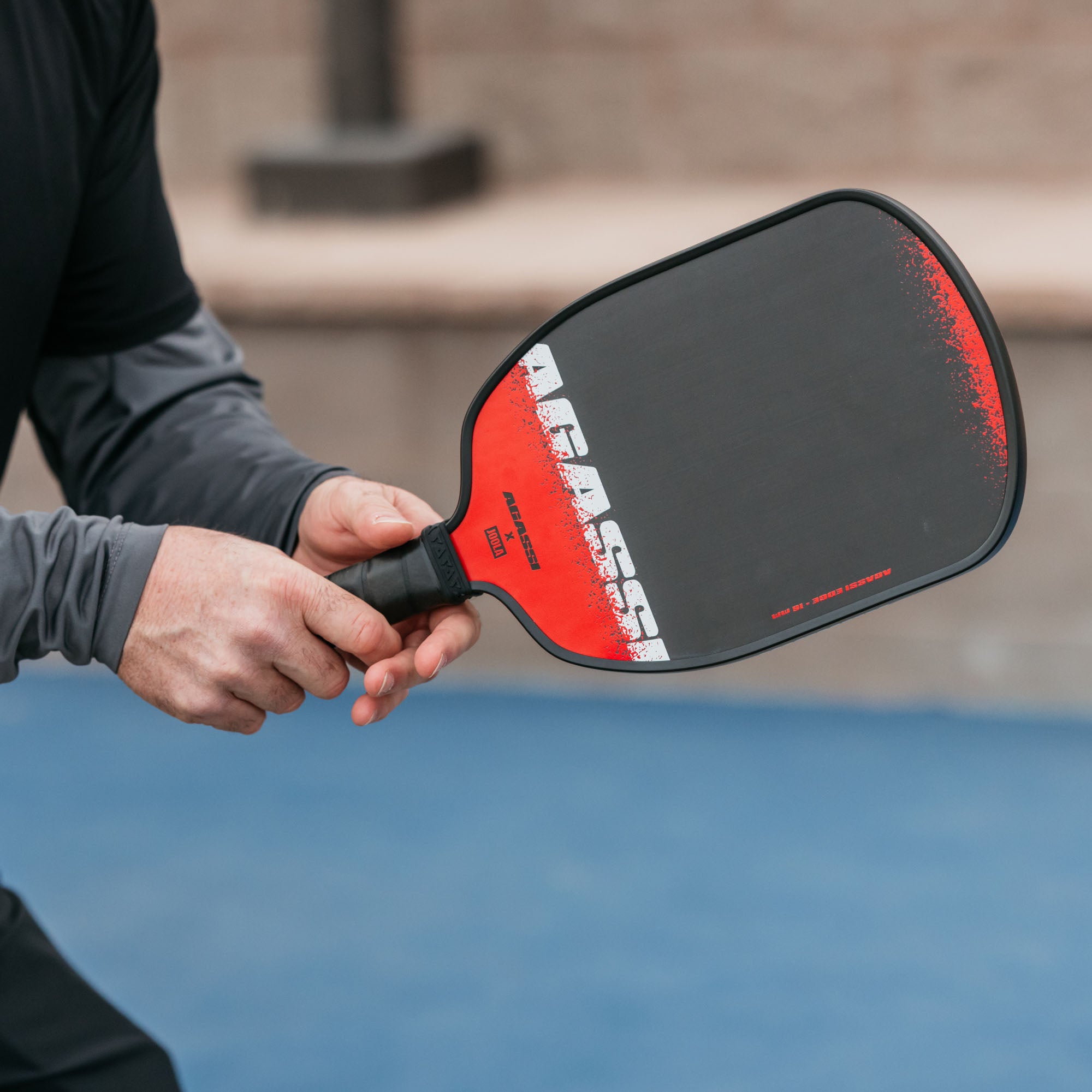 Close up image of Andre Agassi holding a Agassi x JOOLA pickleball paddle.