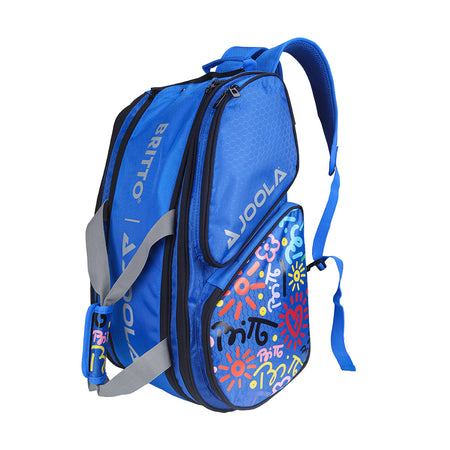 White Background Image: Blue BRITTO x JOOLA Tour Elite pickleball bag. Grey carrying straps, grey JOOLA x BRITO logo and unique BRITTO art design on the side.