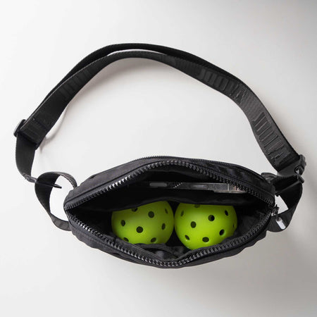 Gray background, overhead look at the inside of the JOOLA Belt Bag.