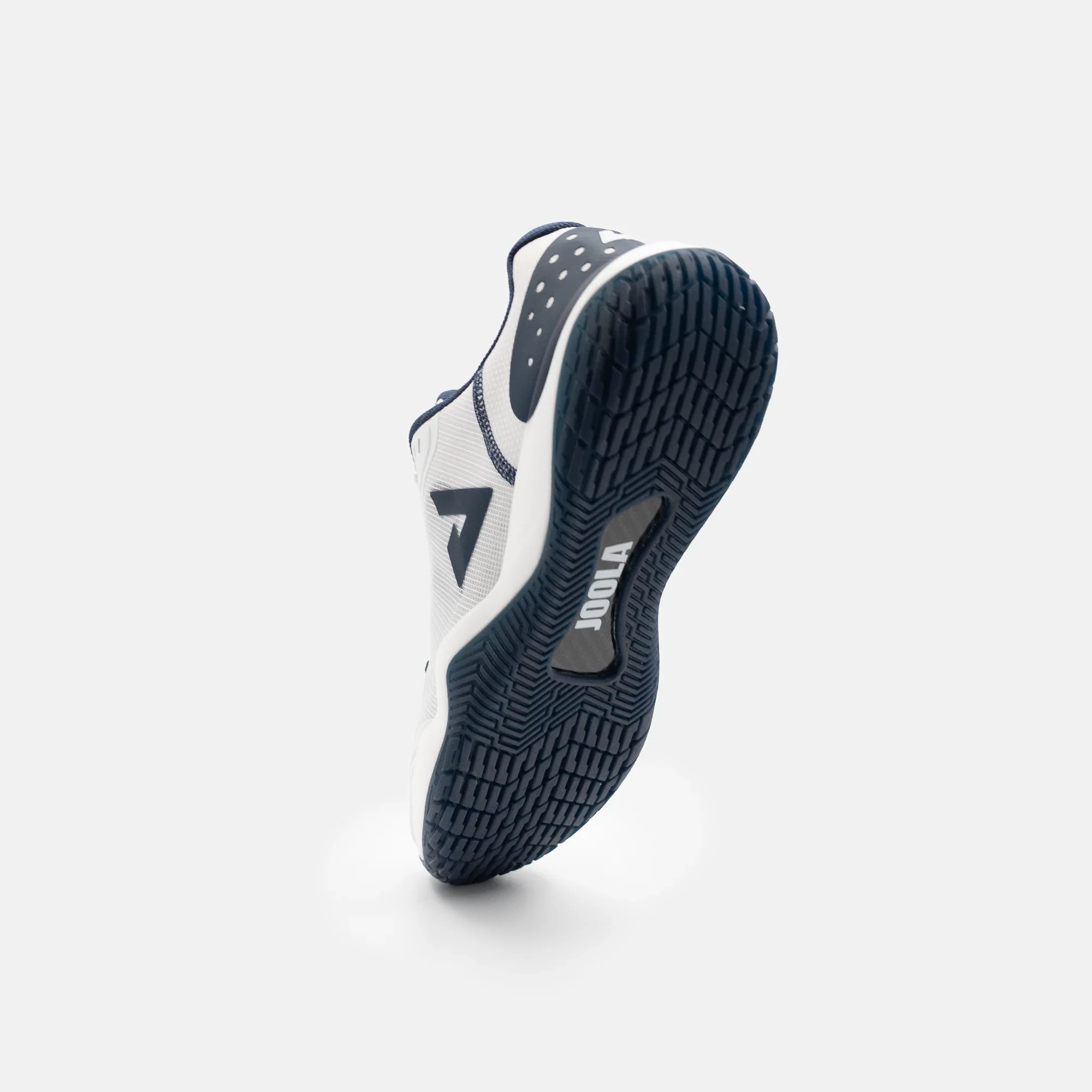 White background, product image showing the tred on the underside of a JOOLA R4LLy pickleball shoe, navy blue and white colorway.