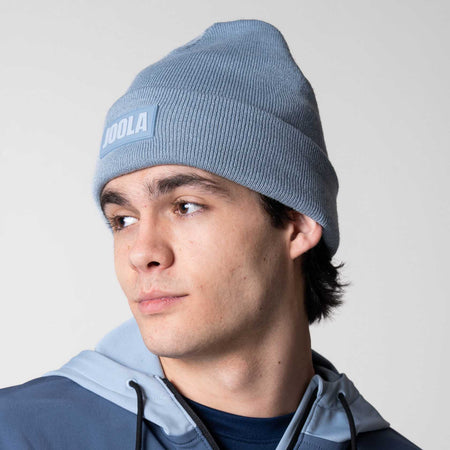 Image of a male model wearing a blue JOOLA Cuff Beanie.