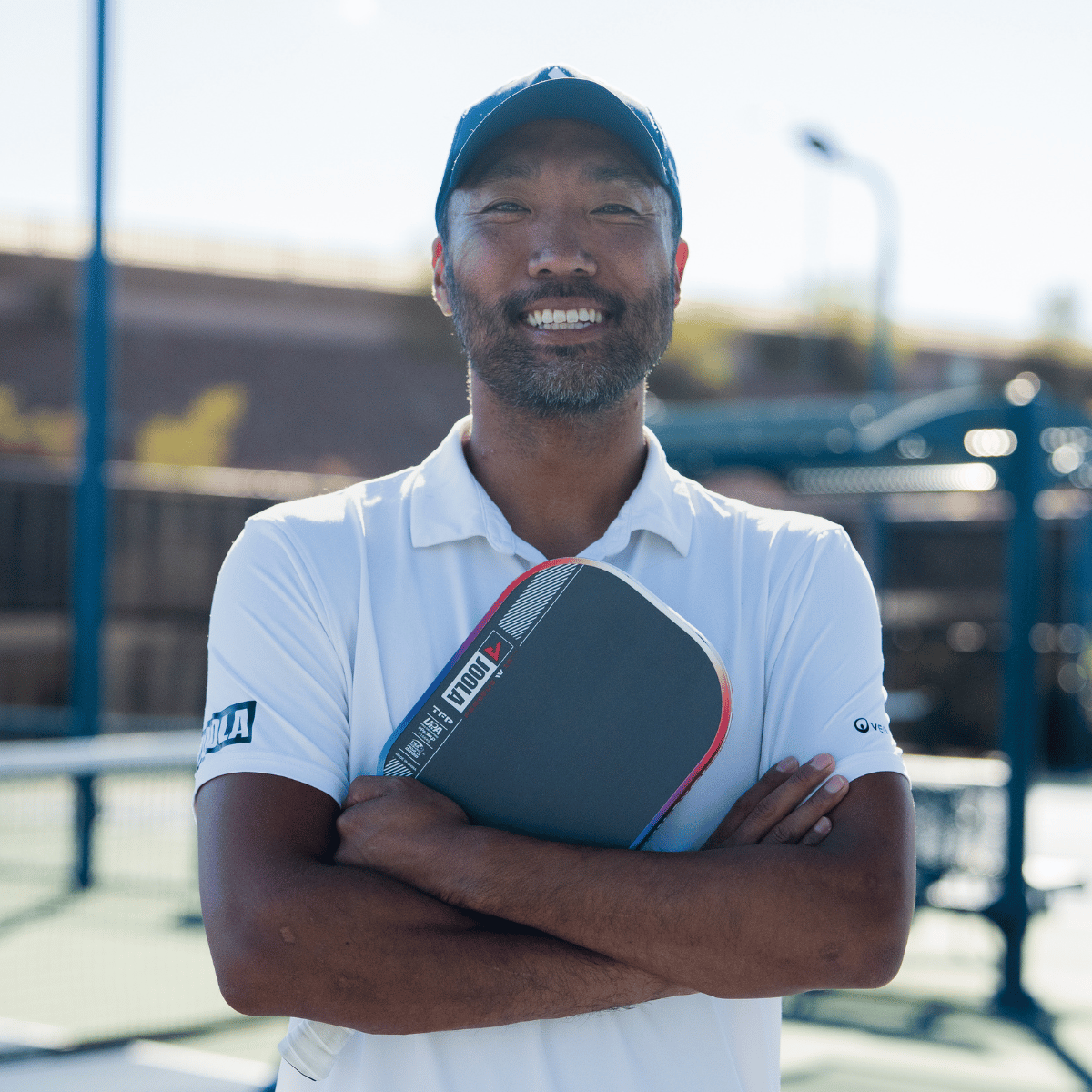 JOOLA Pro Chuck Taylore holding his signature Perseus Pro IV pickleball paddle.