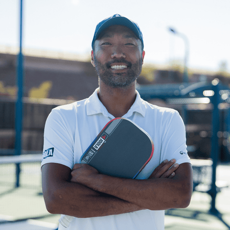 JOOLA Pro Chuck Taylore holding his signature Perseus Pro IV pickleball paddle.
