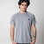 White background, image of a model wearing a gray JOOLA Court Short Sleeve shirt.