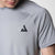 Close up on the black JOOLA trinity logo on the JOOLA Court Short Sleeve Shirt, Gray.