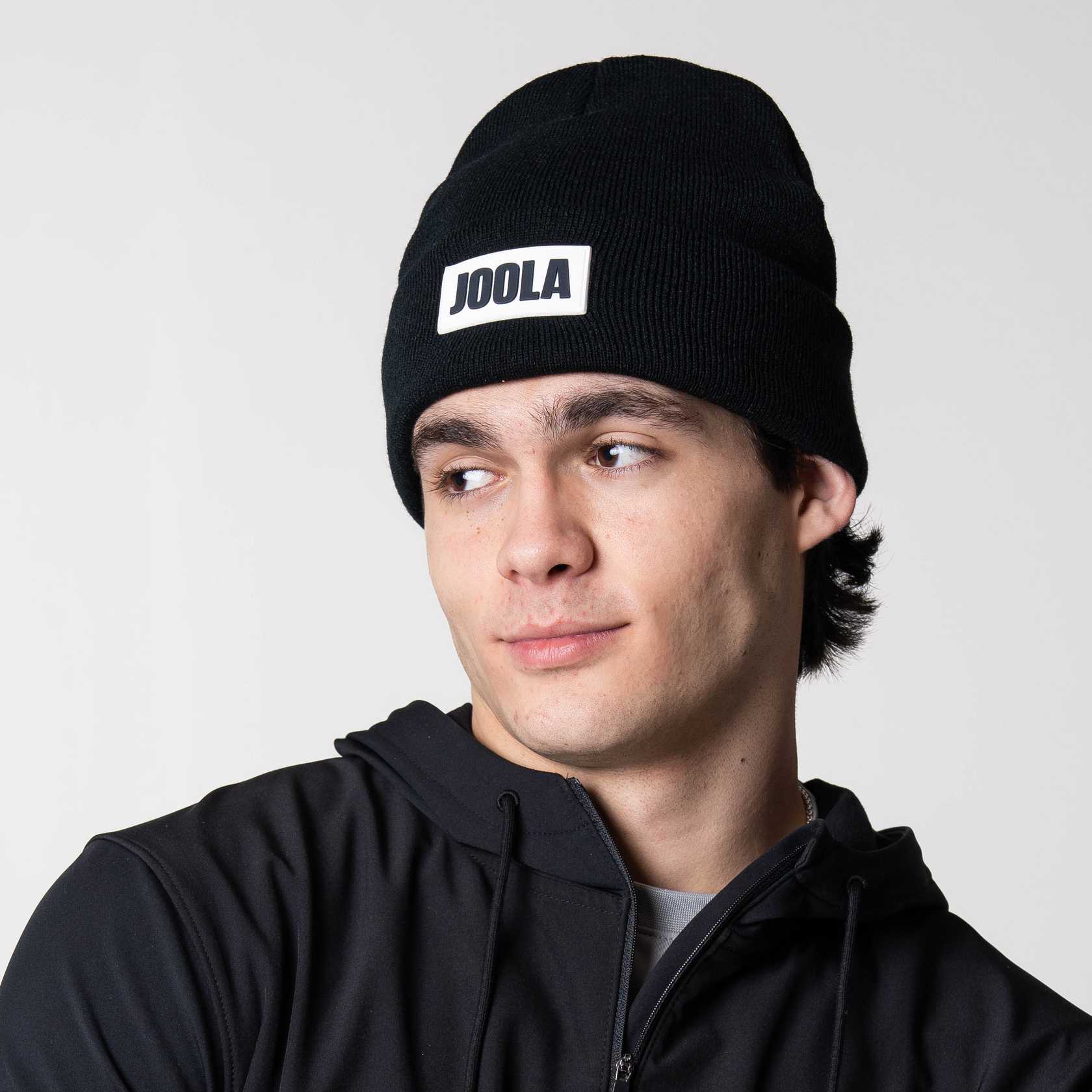 Image of a male model wearing a black JOOLA Cuff Beanie.