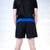 White background, product image showing the rear view of a male model wearing a pair of black and blue JOOLA x Hugo Calderano shorts.