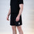 White background, product image showing a male model wearing a pair of JOOLA x Hugo Calderano shorts, image shoes the stylized H on the shorts.