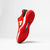 White background, stylized image of the JOOLA R4LLy red pickleball shoe.