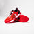 Stylized image of a pair of red JOOLA R4LLy pickleball shoes.