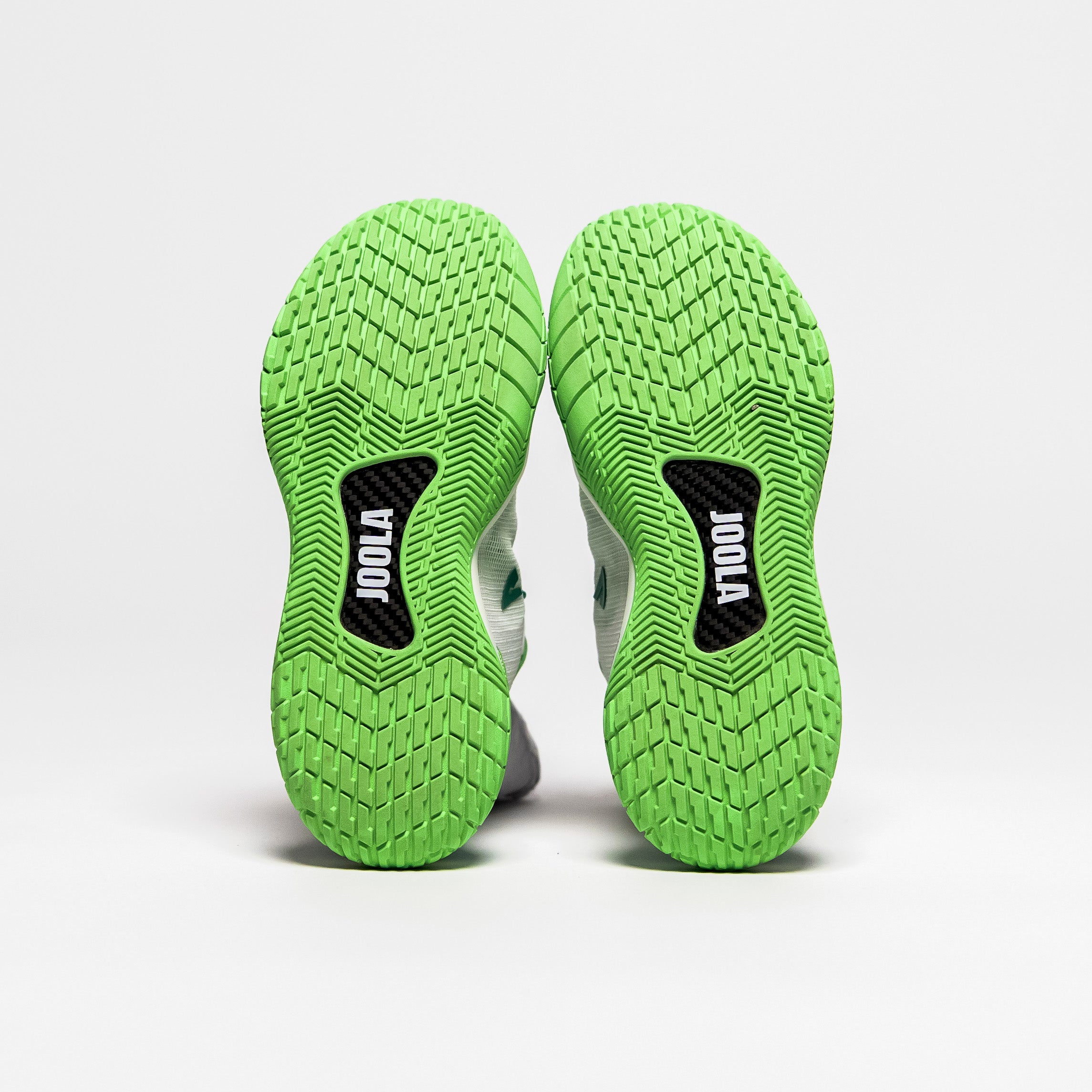 White background, image of the bottom green tred on the JOOLA R4LLy pickleball shoe.
