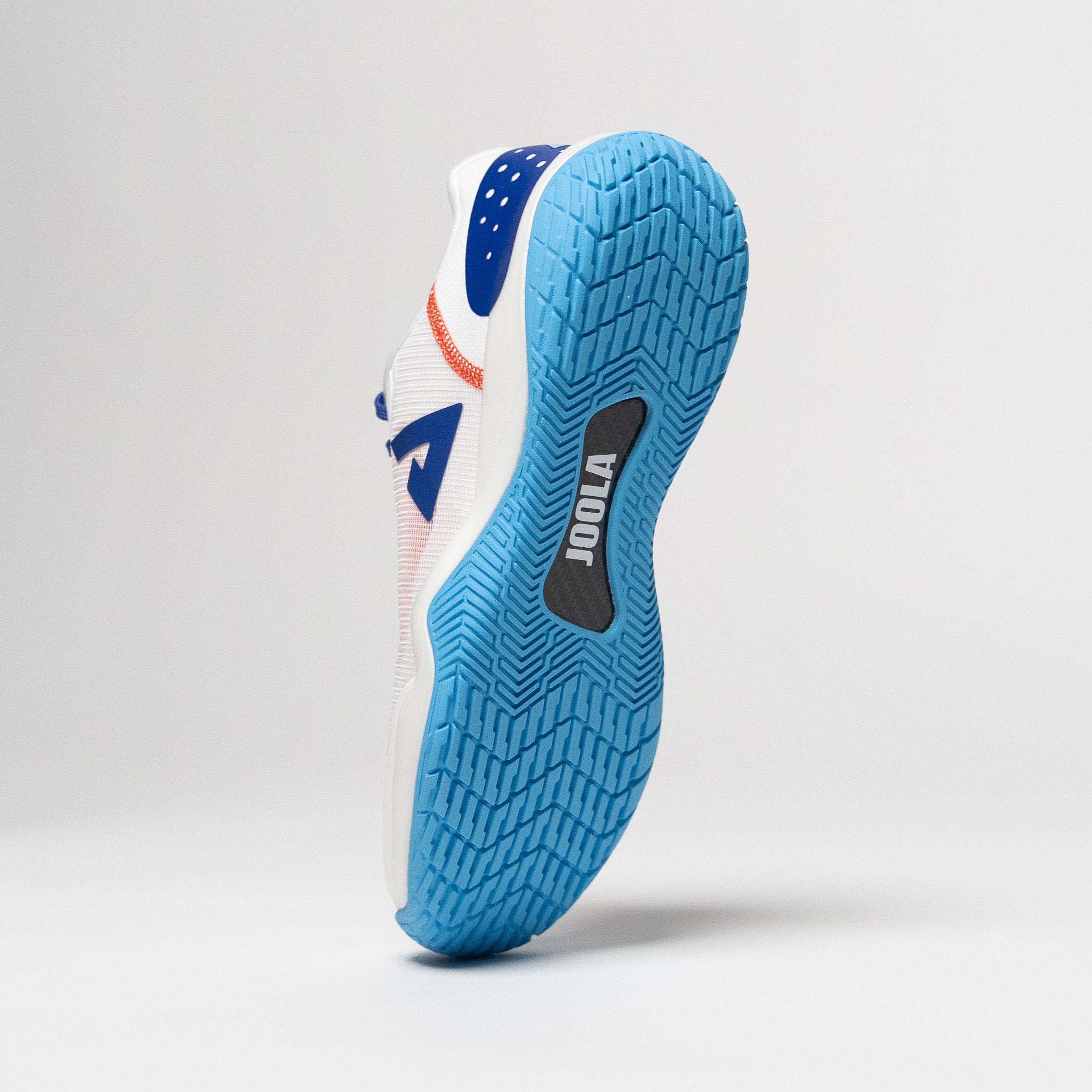 White background, product image of a JOOLA R4LLy pickleball shoe with blue tred and carbon fiber hank with JOOLA logo visibile on the bottom.