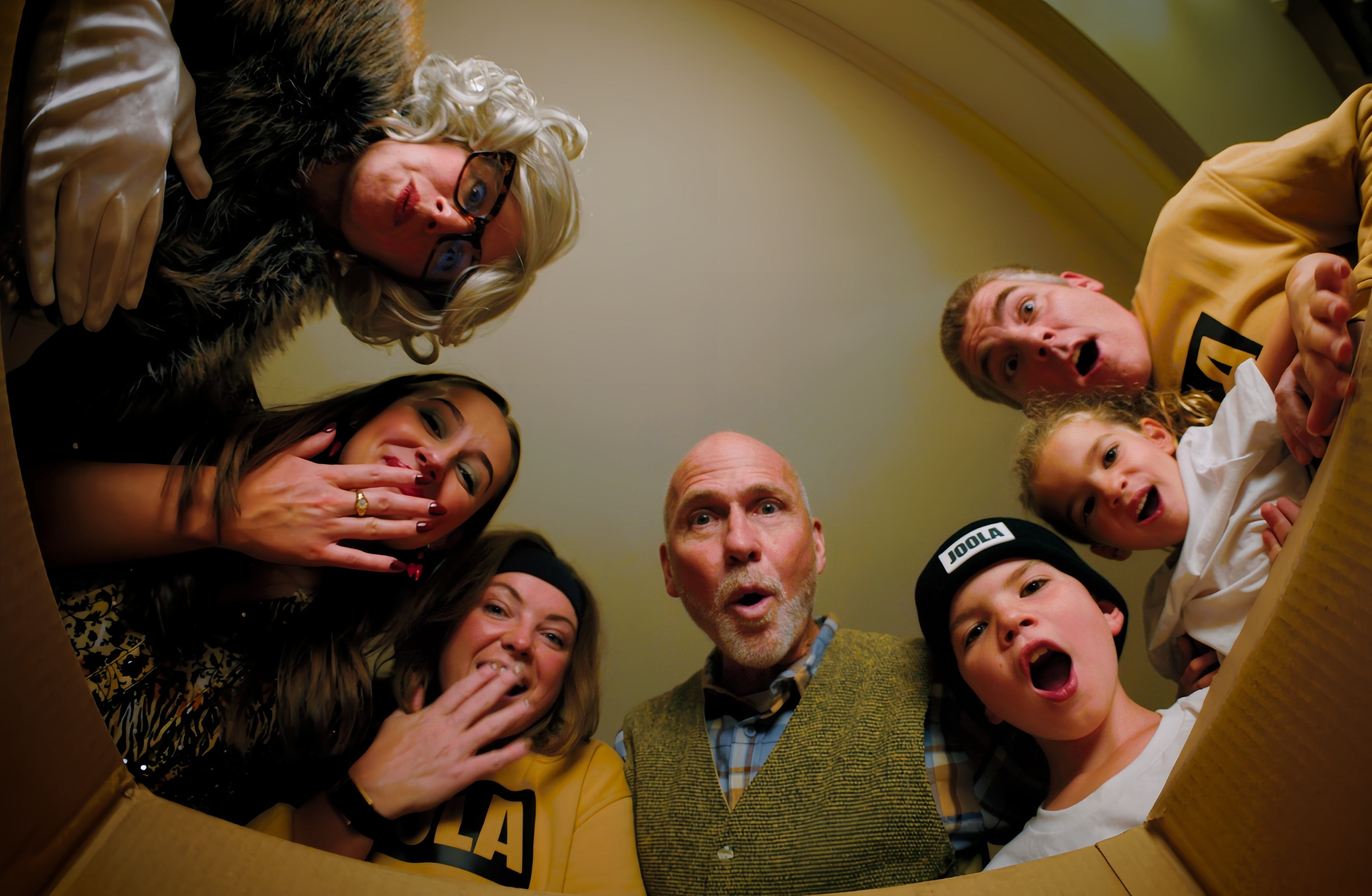 Group of family members looking in to the box.