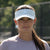 Image of a female model outside wearing a JOOLA Essential Visor, Gravity Gray.