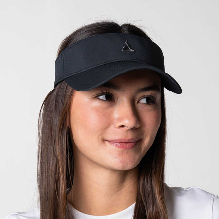 White background, image of a female model wearing a JOOLA Essential Visor, black.