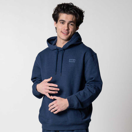 Gray background, image of a male model wearing a JOOLA Fleece Hoodie, Navy.