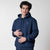 Gray background, image of a male model wearing a JOOLA Fleece Hoodie, Navy.