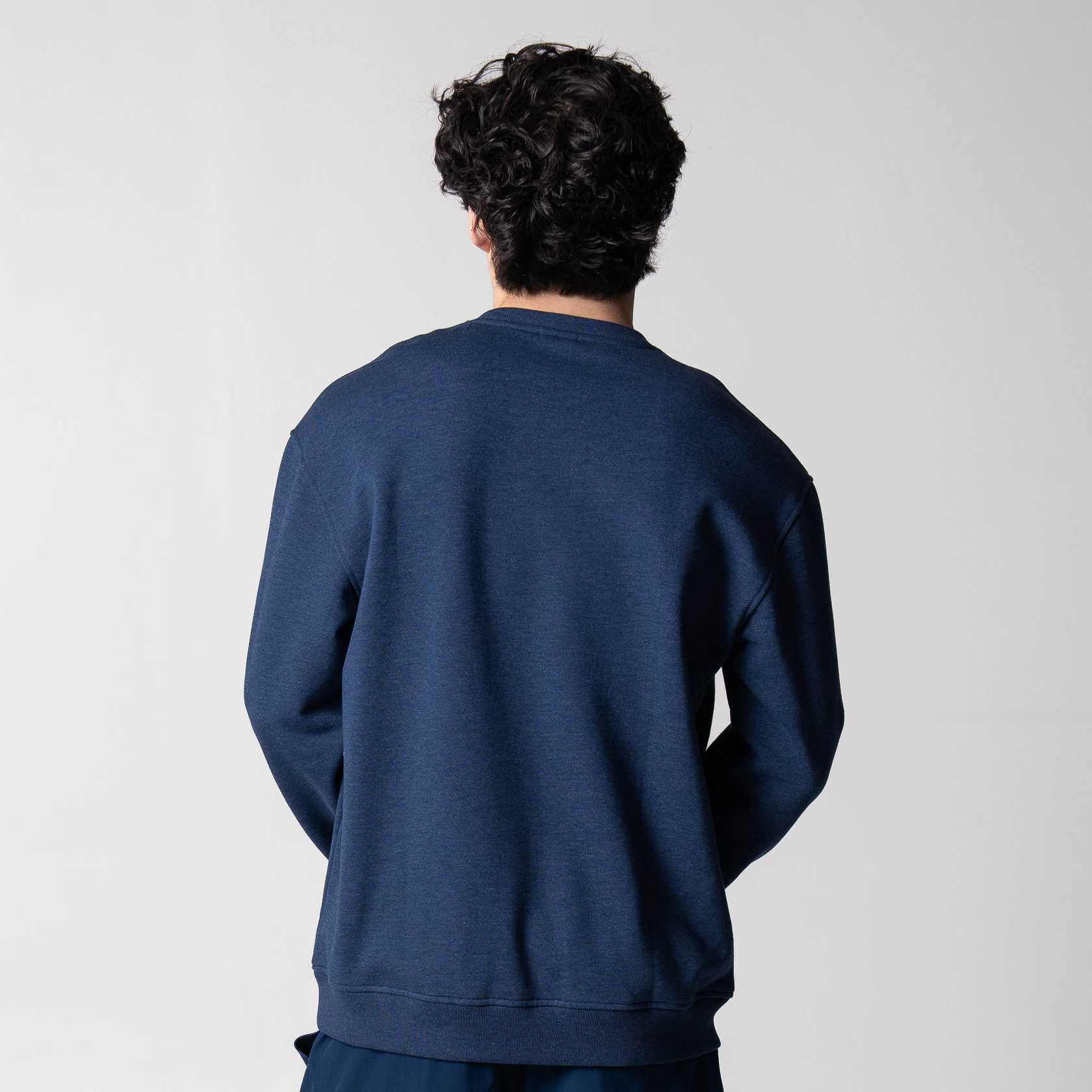 Gray background, image showning the back of a male model who is wearing the JOOLA Fleece Crew, Navy!