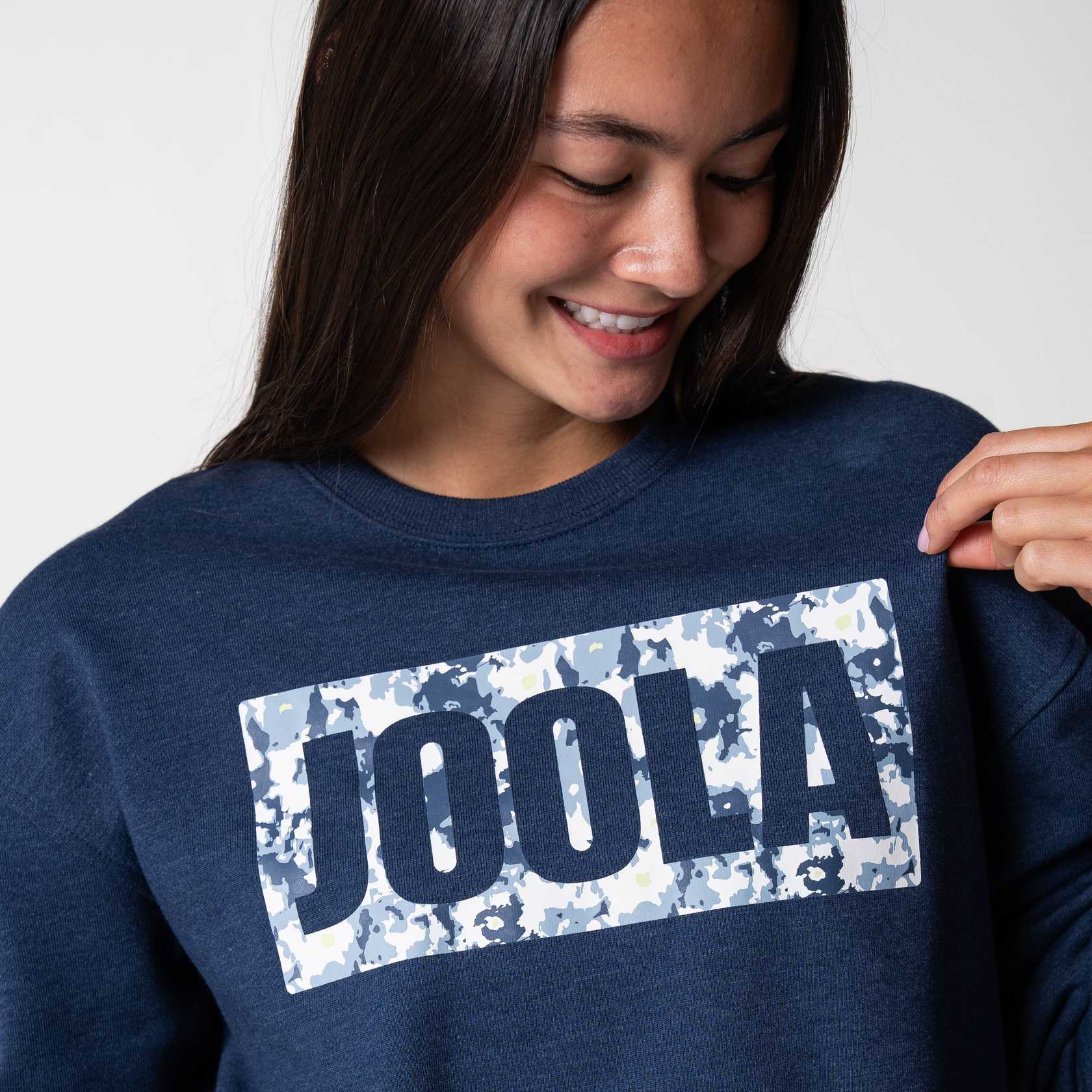 Close up on the JOOLA Camo logo on a blue JOOLA Crew Fleece, Navy.