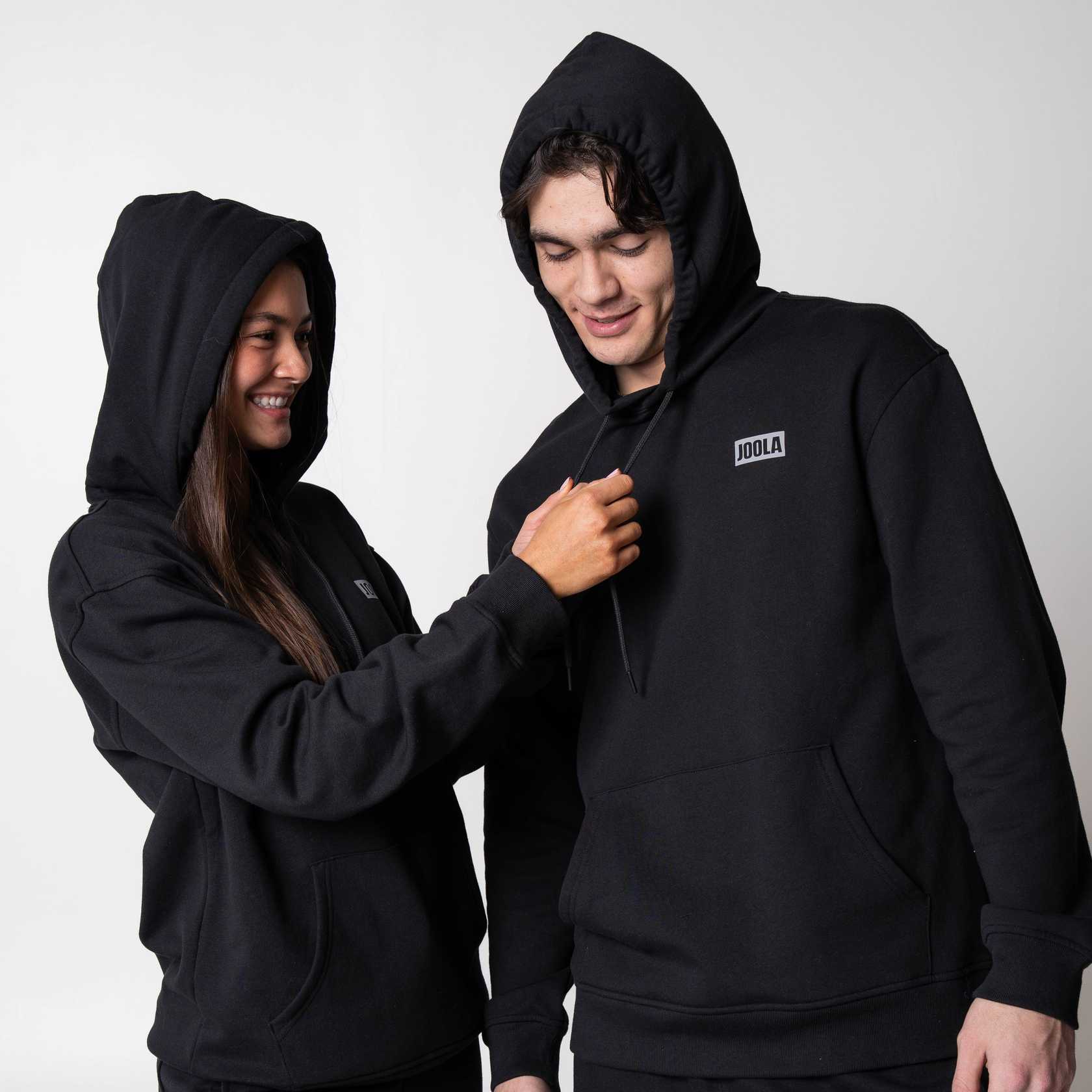 Two models wearing matching JOOLA Fleece Hoodies, Black.