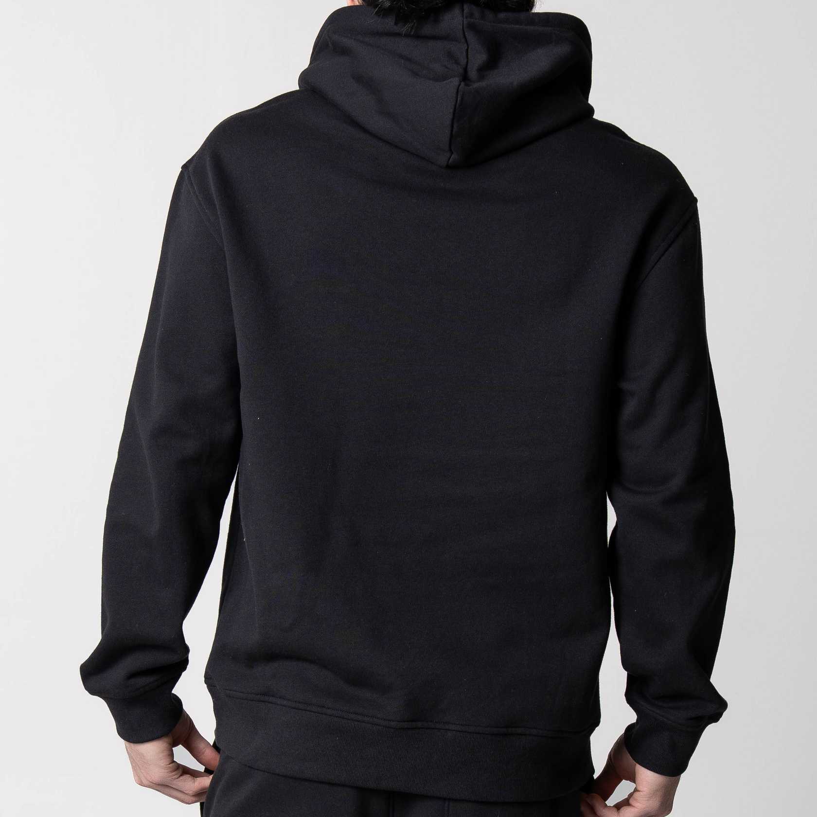 Gray background, image showing the back of a male model who is wearing a black JOOLA fleece hoodie.