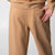 Gray background, image of the back pocket on a pair of JOOLA Fleece Pants, latte.