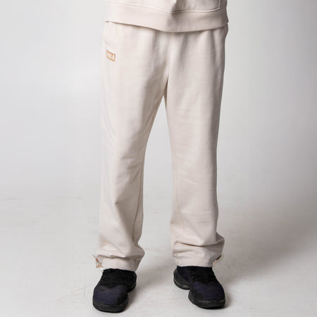 Gray background, image of a pair of sandstone colored JOOLA fleece pants.
