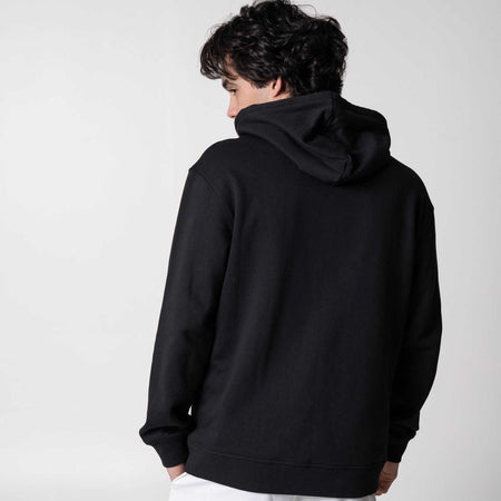Gray background, image of showing the back of a male model wearing a black JOOLA Graphic Hoodie.