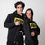 Gray background, two models wearing JOOLA Graphic Hoodies, Black with Yellow JOOLA logo.