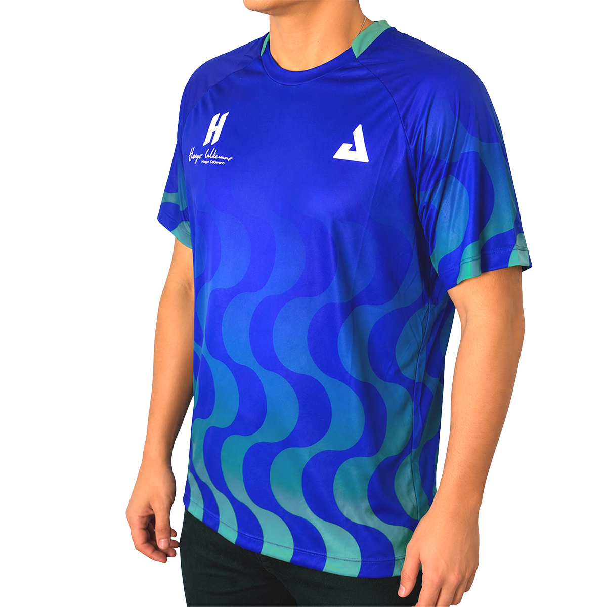 White background, product image showing a male model wearing an Azul  colored Hugo Calderano Copacabana Raglan Short Sleeve.