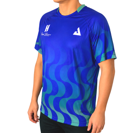 White background, product image showing a male model wearing an Azul  colored Hugo Calderano Copacabana Raglan Short Sleeve.