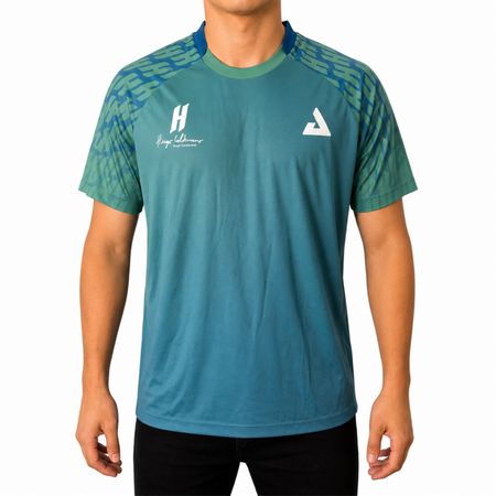White background, image of Hugo Calderano wearing a Hugo Calderano Gradient Monogram Raglan Short Sleeve shirt.