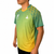 White background, image of Hugo Calderano wearing a Hugo Calderano Gradient Monogram Raglan Short Sleeve shirt. Jungle Green colorway.