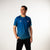 White background, image of table tennis star Hugo Calderano wearing an azul colorway Monogram Crossover Raglan short sleeve shirt.
