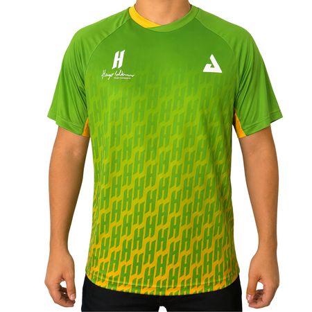 White background, image of a male model wearing a green and yellow, Hugo Calderano Monogram Crossover Raglan Short Sleeve shirt.